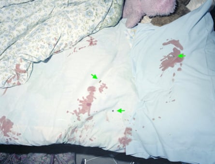 Bullet holes and blood in sheets