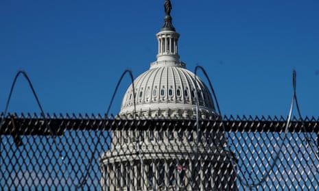 The Capitol building seen behind barbed wire fences.
