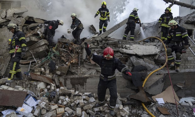 Emergency workers clear the rubble of a school destroyed by a Russian attack in Kharkiv, Ukraine.