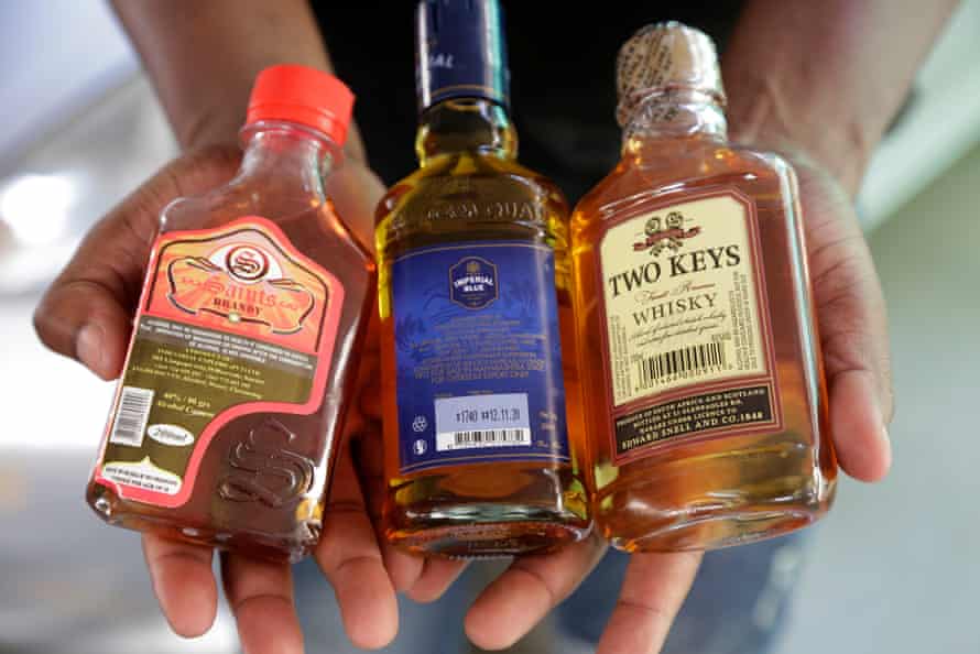 An illicit whisky seller displays his merchandise in Mbare.