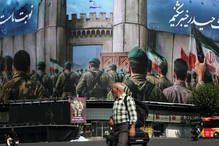 A man walks past a building covered in anti-israel messaging