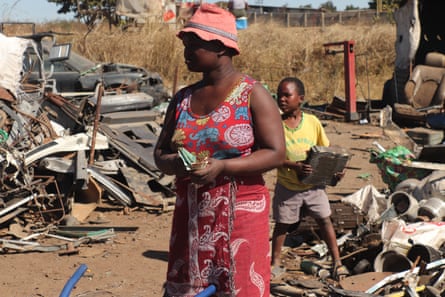 Mercy Muzvidzwa counts her money after making a delivery with her children.