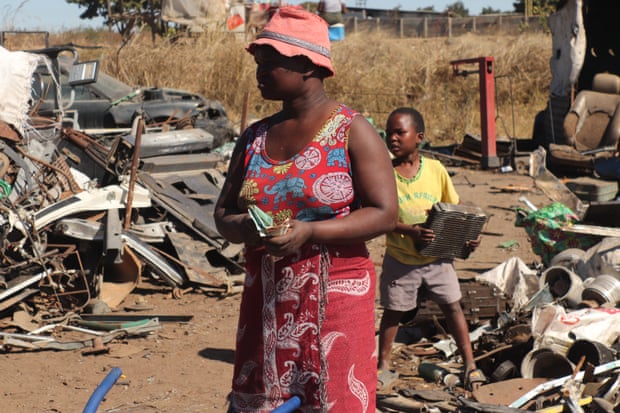 Mercy Muzvidzwa counts her money after making a delivery with her children.