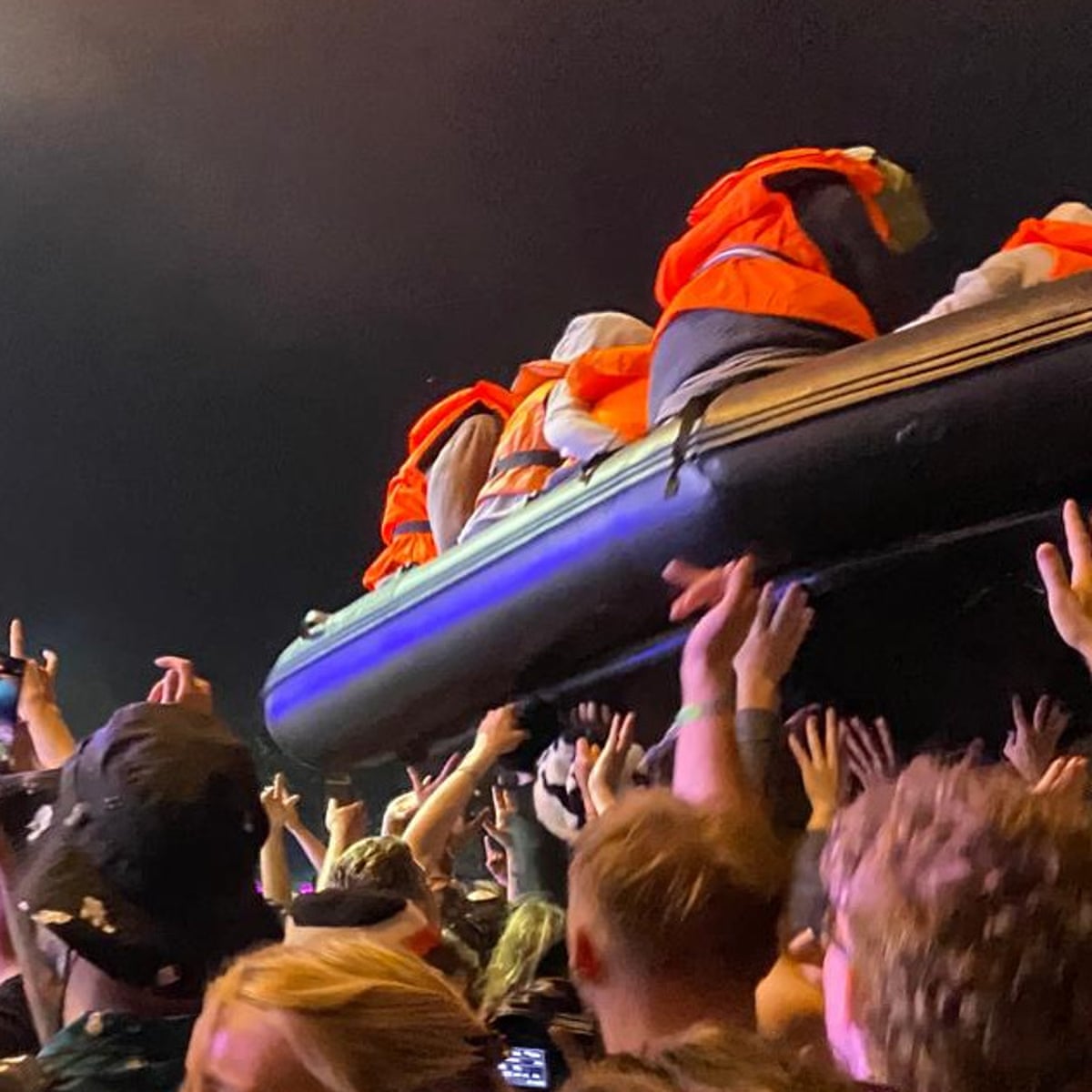 Banksy launches inflatable migrant boat artwork during Idles' Glastonbury set | Glastonbury 2024 | The Guardian