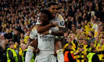 Vinicius Junior of Real Madrid celebrates with Rodrygo after scoring his team's second goal during the Champions League final against Borussia Dortmund.