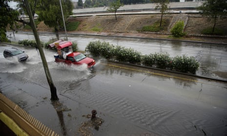 Vehicles make their way through a flooded road in Zona Rio as Tropical Storm Hilary hits the region on Sunday, Aug. 20, 2023, in Tijuana, Baja California.