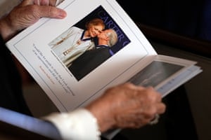 A visitor takes a look at the program before a homage service for Carter at Glenn Memorial church on 28 November