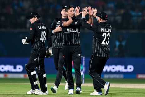 New Zealand's Trent Boult celebrates with teammates after taking the wicket of India's Shreyas Iyer.