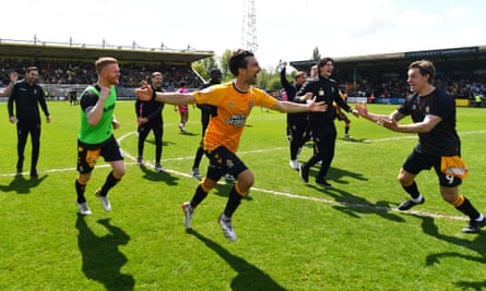 Cambridge United players celebrate on the final whistle.