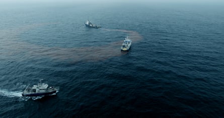 Three research vessels in the Gulf of Maine with a red dye visible in the water between them
