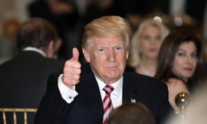 Donald Trump gives a thumbs-up as he has Thanksgiving Day dinner at his Mar-a-Lago estate in Palm Beach, Fla., Thursday, Nov. 22, 2018.