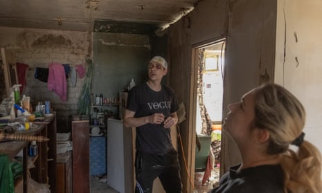 Maksym, 33, and his wife Natasha, 39, visit their apartment that was heavily damaged during a recent Russian attack on the city, in Kharkiv.