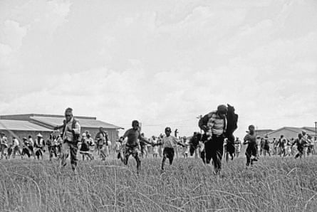 Protesters fleeing after police open fire on a peaceful crowd in Sharpeville, near Johannesburg, South Africa, on 21 March 1960.