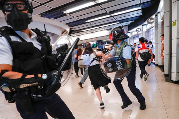 Anti-government protesters run away from riot police as they gather at Sha Tin Mass Transit Railway (MTR) station to demonstrate against the railway operator, which they accuse of helping the government, in Hong Kong, China September 25, 2019.