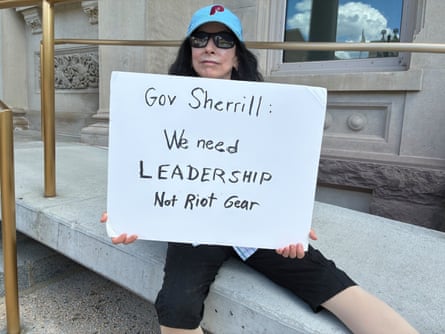 a woman holding a sign