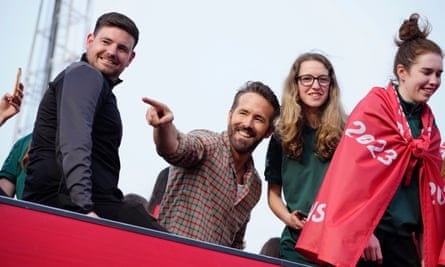 The co-owner of Wrexham AFC, Ryan Reynolds (centre left), celebrates the team’s promotion to the Football League