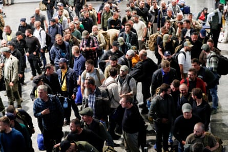 Overhead view of a crowd of men standing on tarmac