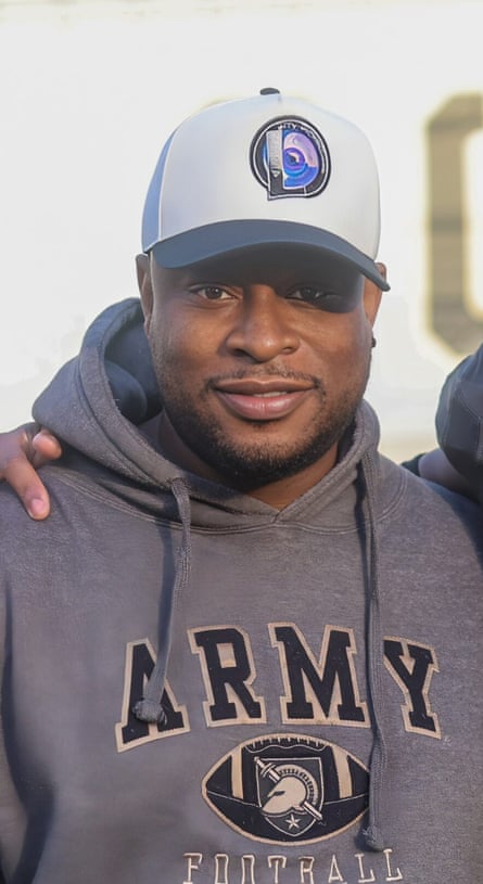 A younger middle-aged man in an army hoodie