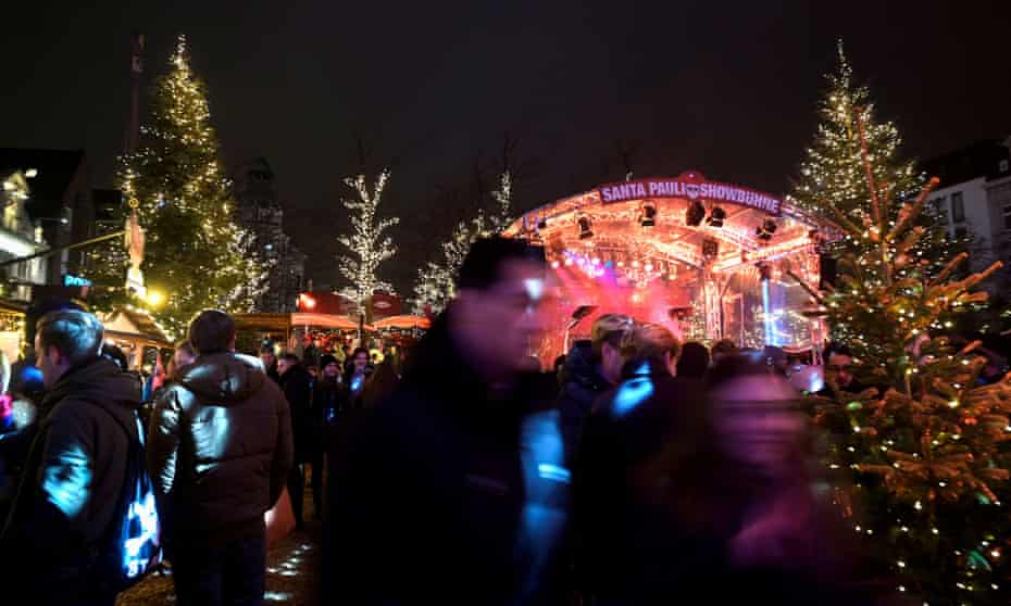 People visit a Christmas market open only to visitors who have been vaccinated or have recovered from Covid-19, in the Reeperbahn district of Hamburg, Germany