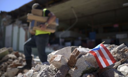 Store owners remove supplies from Ely Mer Mar hardware store, which partially collapsed after an earthquake struck Guanica, Puerto Rico Tuesday.