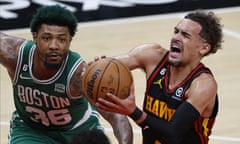 The Hawks’ Trae Young (R) drives to the basket as Celtics guard Marcus Smart (L) defends during Thursday’s first half.