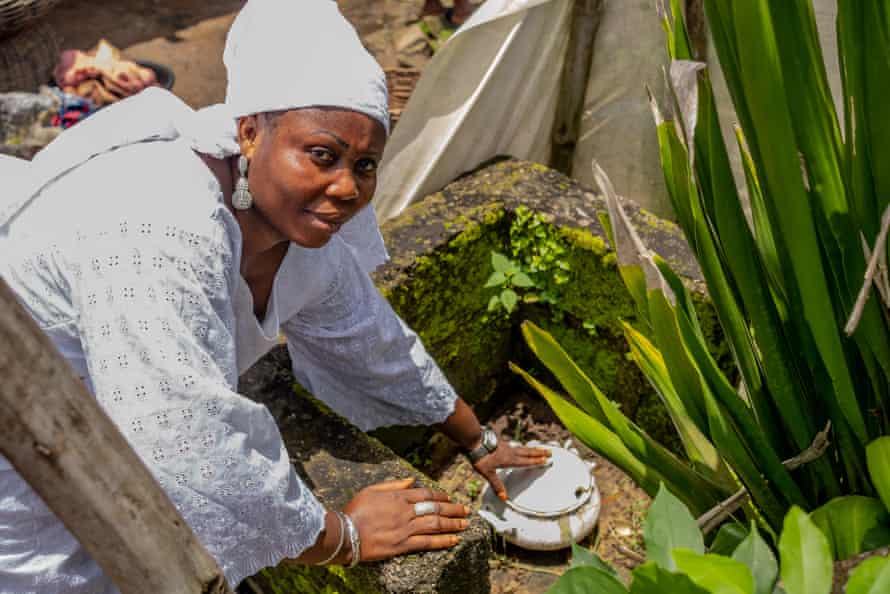 Folasade Ojikuti pointing out her ‘shrine’ at the back of the market, on the dock of the lagoon