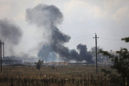Smoke rises over the site of explosion at an Russian ammunition depot in Crimea.