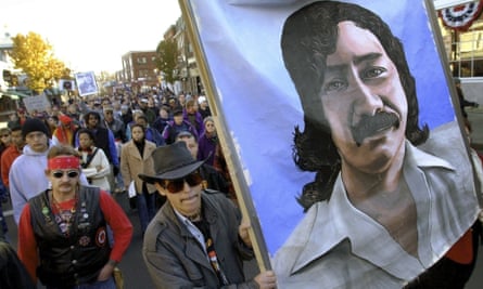 Marchers carry a painting of Leonard Peltier during a march in Plymouth, Massachusetts, in November 2001