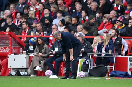 Ange Postecoglou puts his hands on his knees.