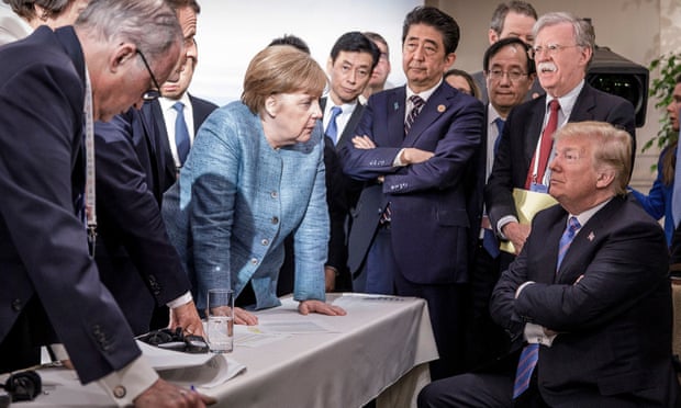 World leaders surround Donald Trump and his national security adviser, John Bolton.