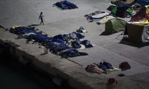 People sleep at the port of Chios island, Greece.