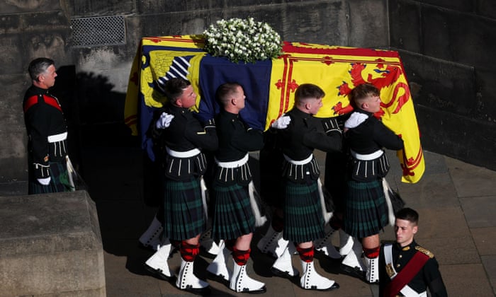 Pallbearers carry the coffin of Queen Elizabeth II into a hearse.