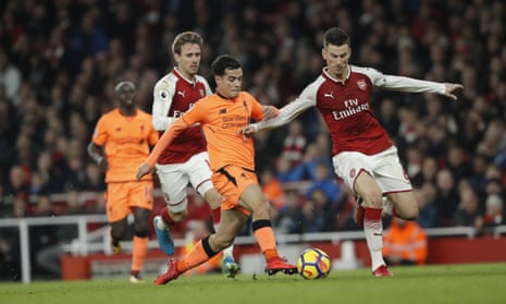 Laurent Koscielny covers the mistake by Monreal to deny Philippe Coutinho.