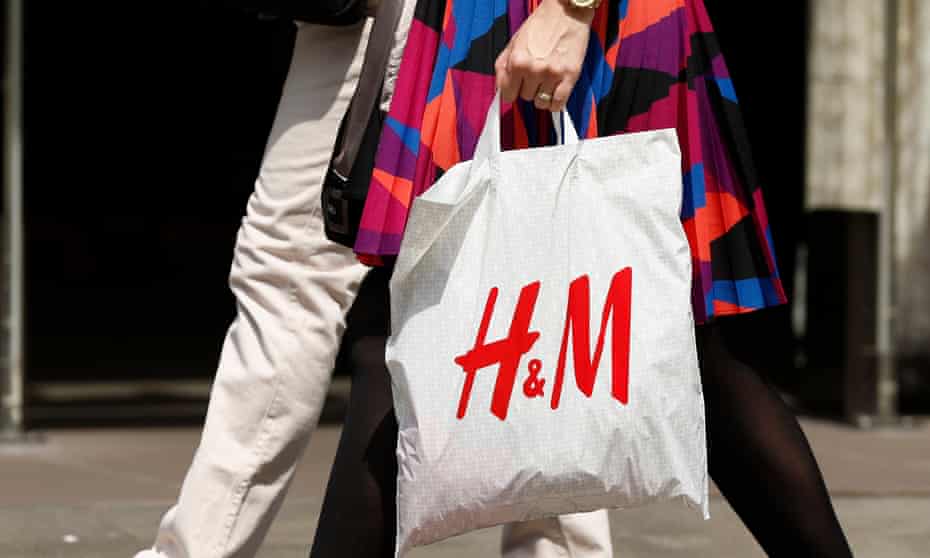 Woman carrying H&M carrier bag