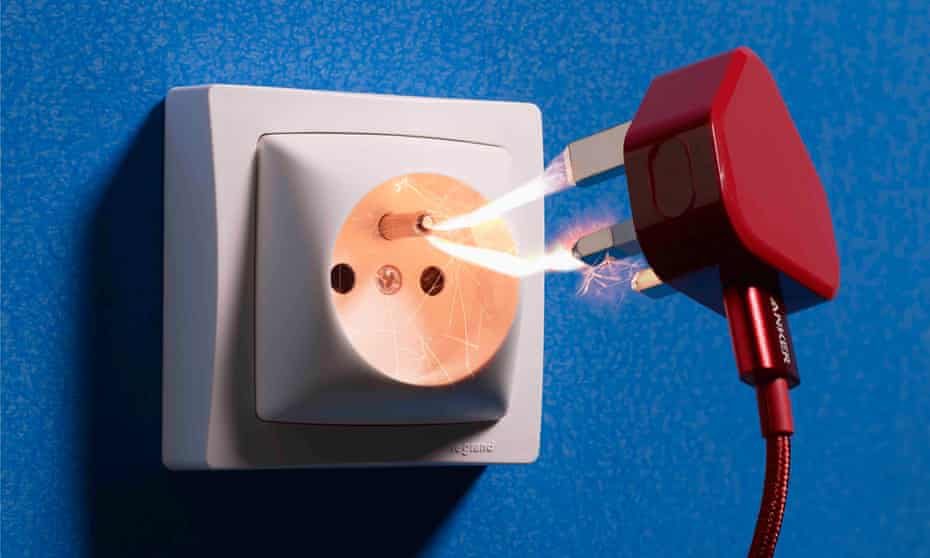 A picture of a UK plug and a European socket, with sparks between them