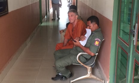 Australian Garry Mulroy (in orange) is seen before a court hearing in Phnom Penh, Cambodia in March. He has flown out of the country after being released from jail on appeal. 