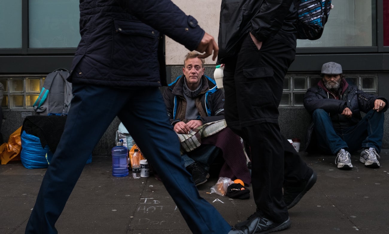 Homeless man begs in London