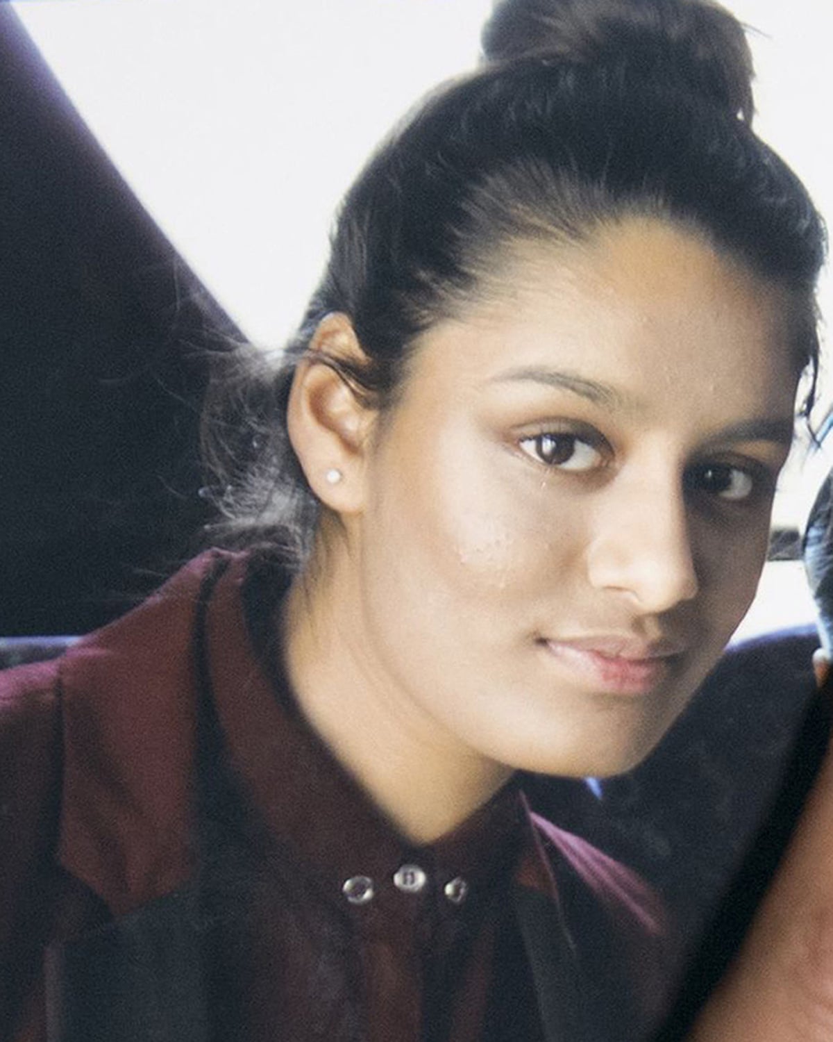 Portrait of Shamima as a young woman, in western clothes and makeup
