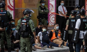 Police detain protesters on the street in Hong Kong