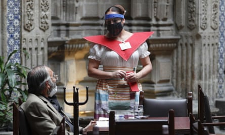 A waitress at Mexico City’s iconic Sanborns of the Azulejos restaurant, wearing a mask and face shield.