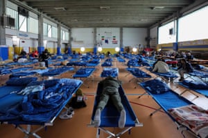 Evacuees rest in a gymnasium in Bologna