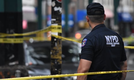 NYPD officer safeguards a crime scene.