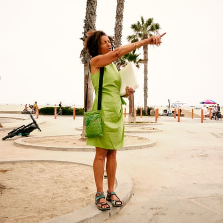 Woman in green dress pointing