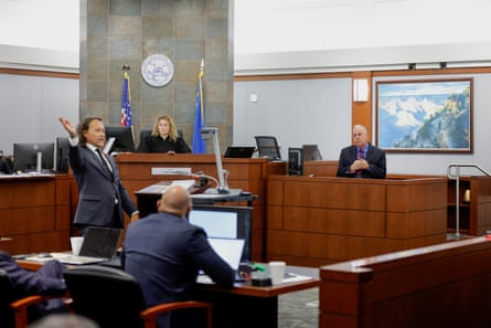 a former Las Vegas Metro Police Department officer is questioned at the stand as a judge watches on