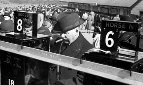 A racegoer placing a bet on the Tote which was first founded by the government in 1928.