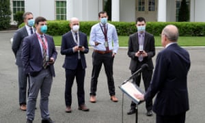 Is that your idea of six feet? The men in suits and (with a glaring exception) masks.White House Economic Council Director Larry Kudlow speaks to news reporters following a television interview outside of the West Wing at the White House earlier today.