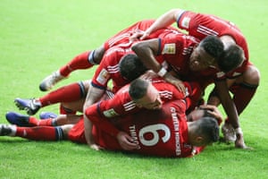 Rafinha is swarmed by his teammates after scoring