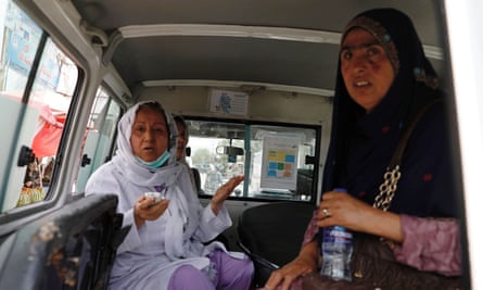 Afghan women sit in an ambulance after being rescued by security forces during the hospital attack.