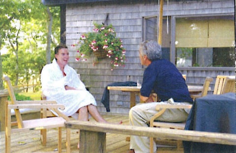 Peter Mandelson, wearing a white bathrobe, talking to Jeffrey Epstein