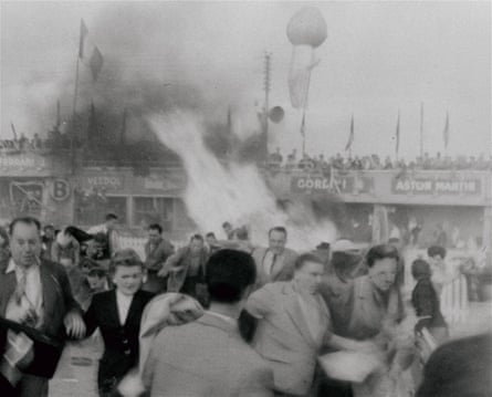 Spectators flee the searing flames of a smashed Mercedes racing car after an accident at Le Mans, France, endurance race which killed more than 80 persons, June 11, 1955